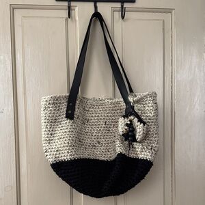 Hand crochet tote with hand stitched lining and black leather straps.